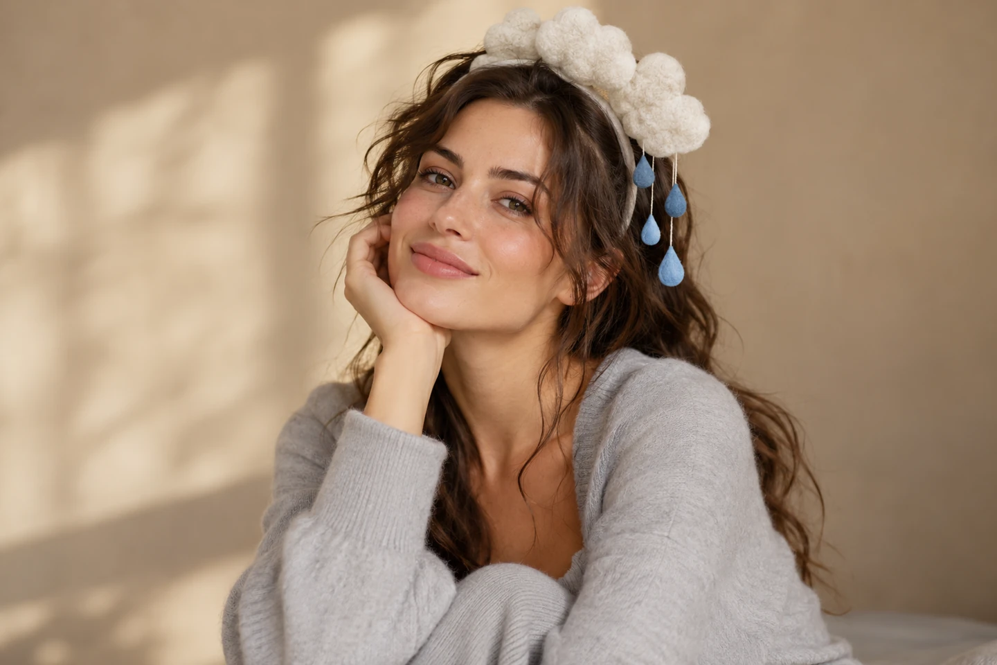Adult woman in pale gray clothes with a compact felt cloud headband and blue raindrop accents